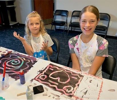 Two kids finger painting